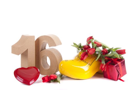 Number of age in a colorful studio setting and Dutch looking attributes like a clog woonden shoe and tulips