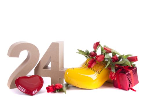 Number of age in a colorful studio setting and Dutch looking attributes like a clog woonden shoe and tulips