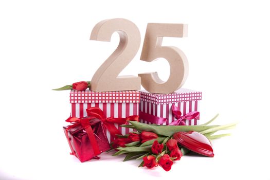 Number of age in a colorful studio setting with a red heart and gifts and tulips