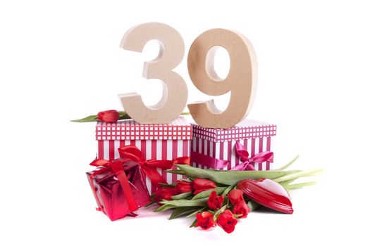 Number of age in a colorful studio setting with a red heart and gifts and tulips