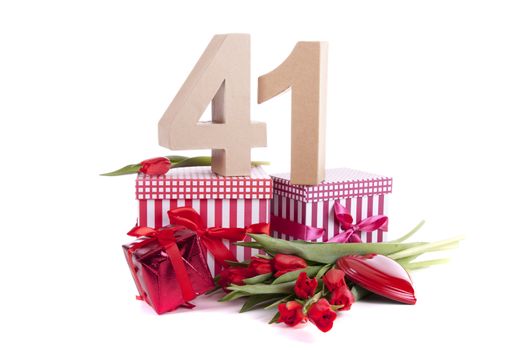 Number of age in a colorful studio setting with a red heart and gifts and tulips