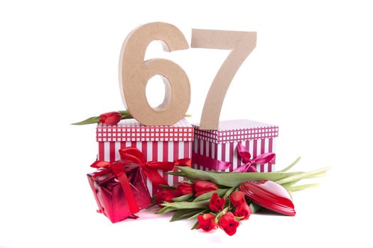 Number of age in a colorful studio setting with a red heart and gifts and tulips