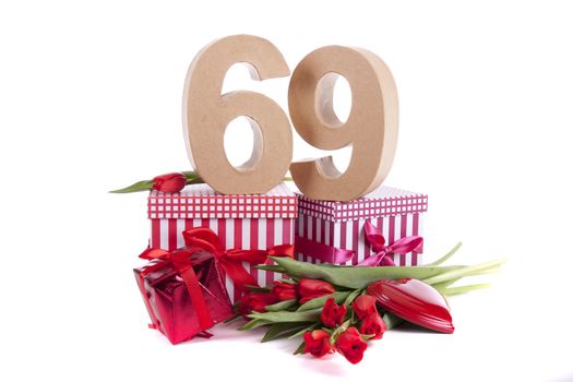 Number of age in a colorful studio setting with a red heart and gifts and tulips