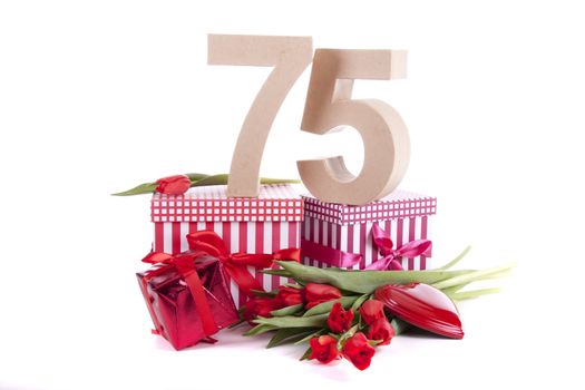 Number of age in a colorful studio setting with a red heart and gifts and tulips