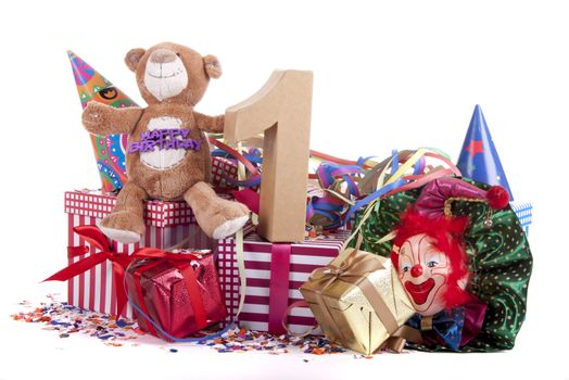 Number of age in a colorful studio setting with paper party hats, a red heart and gifts on a bottom of confetti for  childrens birthday party

