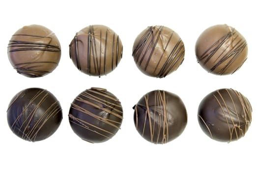 Eight Round Dark and Milk Chocolate Truffles  with Swirls Isolated on White Background