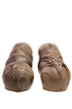Two Rows of Dark and Milk Chocolate Truffles Bonbon Shallow Depth of Field Isolated on White Background