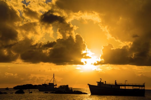 Golden sunrise over boats in Caribbean harbor of San Andres, Colombia