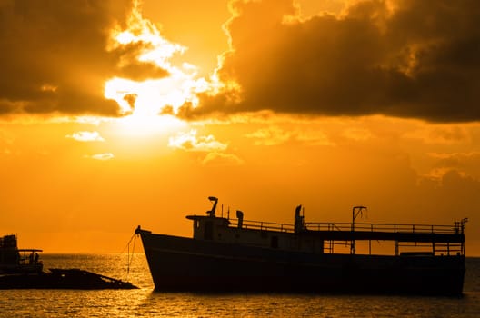 Golden sunrise over boats in Caribbean harbor of San Andres, Colombia