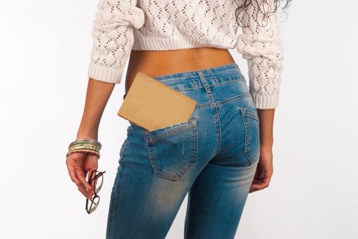 Old book in a tight fitting sexy jeans pocket