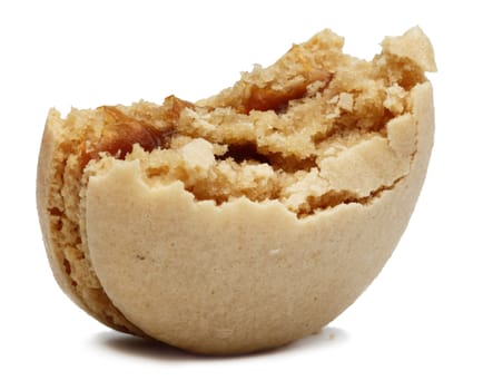 Image of a macaron with a bite missing against a white background.
