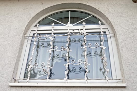 A semi-circle shaped window with nice grilles