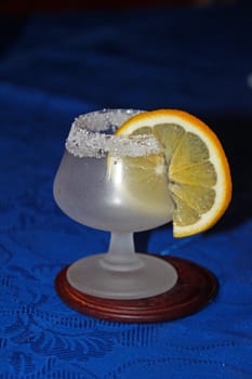 A goblet decorated with sugar crystals and lemon slice