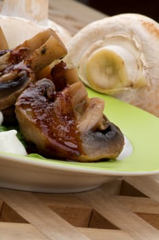 Cooked Grill Champignons with Sauce and Sour Cream Plate closeup on Wood Square background and Raw Mushrooms 
