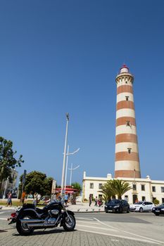 View of Aveiro lighthouse and black bike in foreground in summer, in Aveiro, Portugal, on July 31, 2011