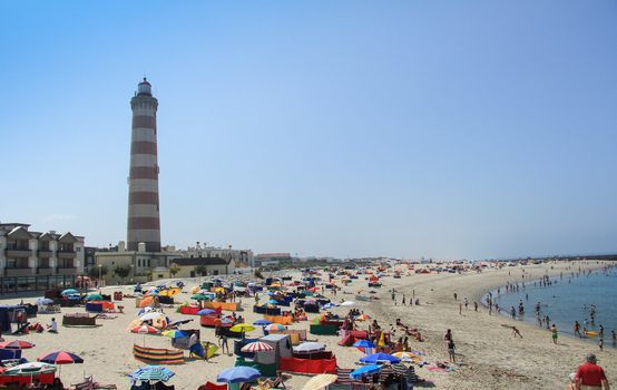 Summer view of Barra beach with the Aveiro lighthouse in background, in Aveiro, Portugal, on July 31, 2011