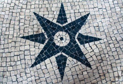 Clear stone blocks pavement texture with a dark central star motive for background