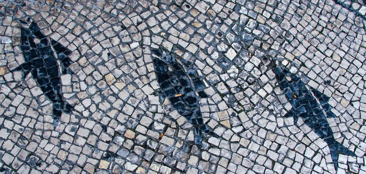 Clear stone blocks pavement texture with a dark central fishes motive for background