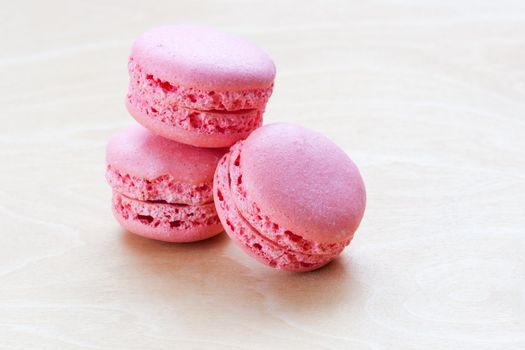 pink macaron on wooden background