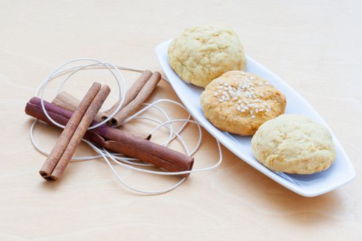 biscuits on a plate and cinnamon sticks