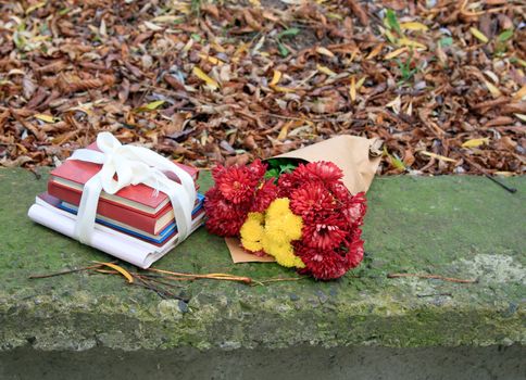 bouquet of chrysanthemums and a stack of books