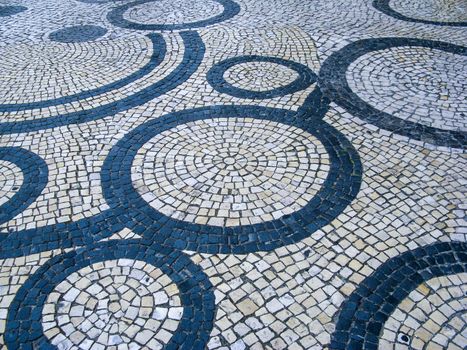 Clear stone blocks pavement texture with a dark central circles loop motive for background