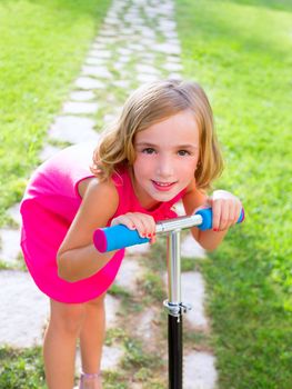 child happy girl playing with scooter in garden happy smiling