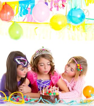 children happy girls blowing birthday party chocolate cake candles