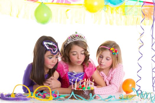 children happy girls blowing birthday party chocolate cake candles