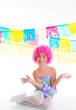 child kid girl with party clown pink wig funny expression and garlands