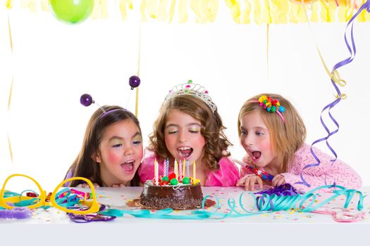 children kid girls birthday party looking excited chocolate candles cake