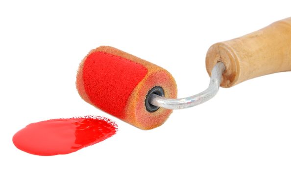 Closeup of roller applying bright red paint, isolated on a white background