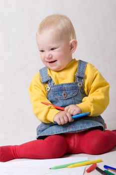 small girl with pencils in hands