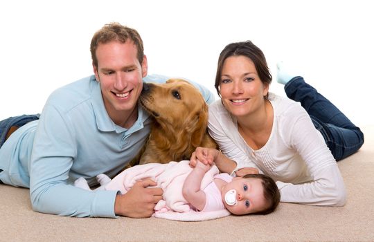 Baby mother and father happy family with golden retriever dog on carpet