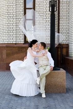 bride and groom near the wall