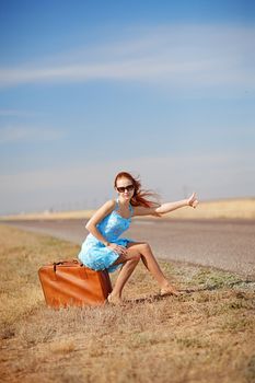 girl on the road waiting for a car