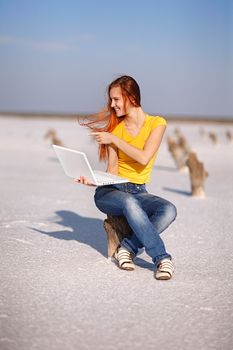 girl with notebook on the sand