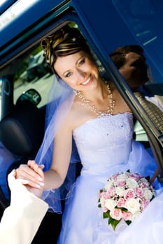 groom helps to bride to leave a car