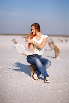 girl with notebook on the sand