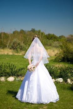 bride in the park by back