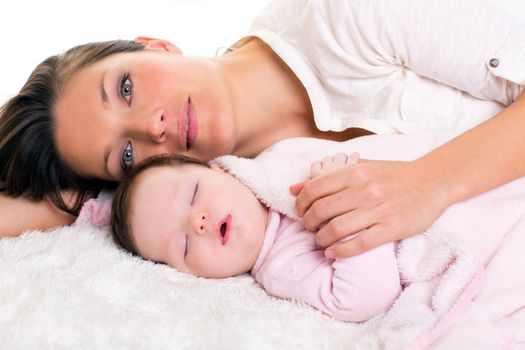 Baby girl sleeping with mother care near on white fur