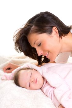 Baby girl sleeping with mother care near on white fur