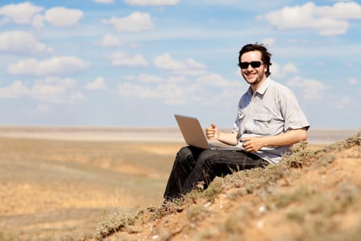 man with laptop outdoors