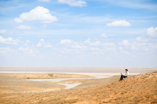 man with laptop on the hill