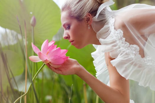 happy bride smelling a lotus flower