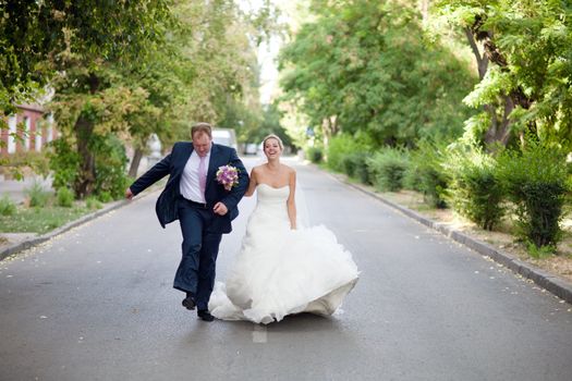 bride and groom walking down the street