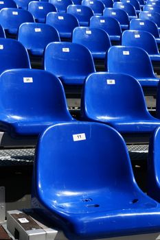 Rows of blue seats on modern stadium