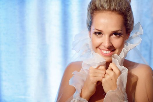 portrait of happy young bride with veil