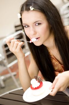 girl eating a cake in cafe