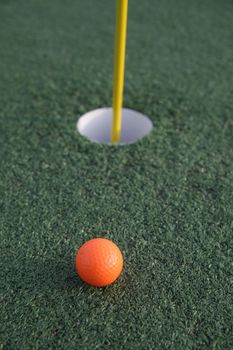Close up of a pin and cup on a golf hole